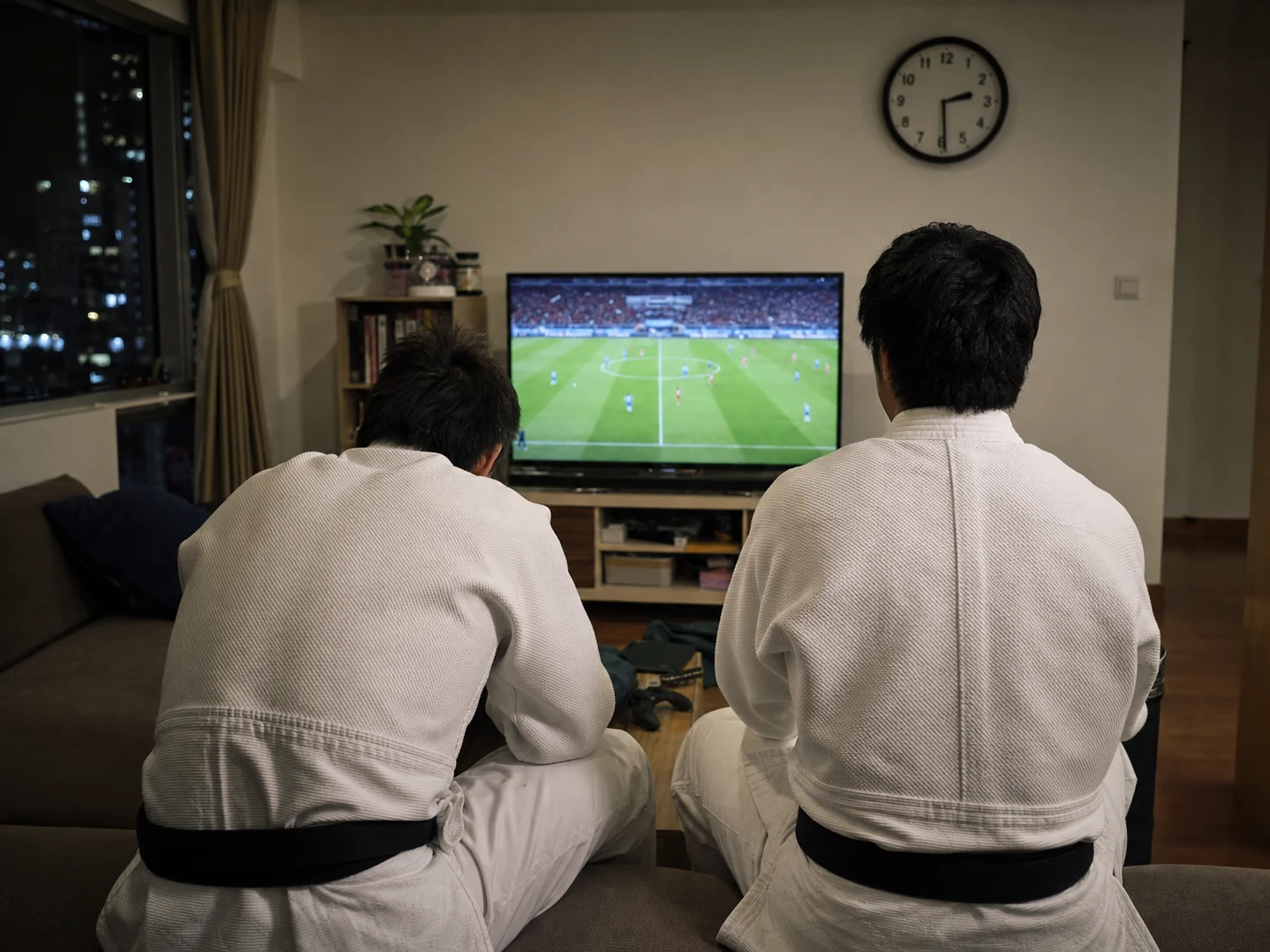 Two judoka watching the World Cup late at night before training the next day